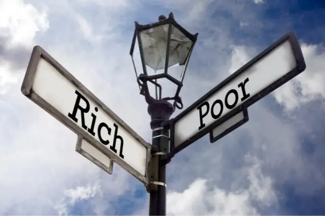 two way street with a sign that says "rich" and sign that says "poor"