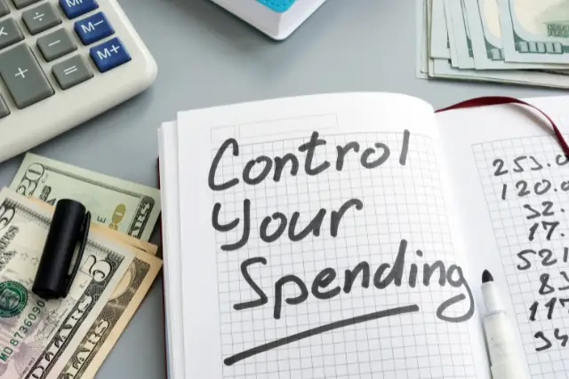 Notebook that says control your spending