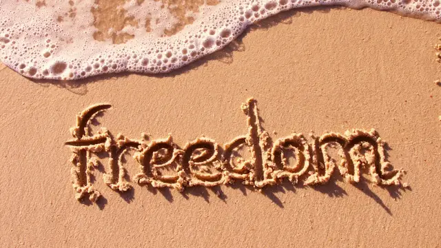The word freedom written in the sand