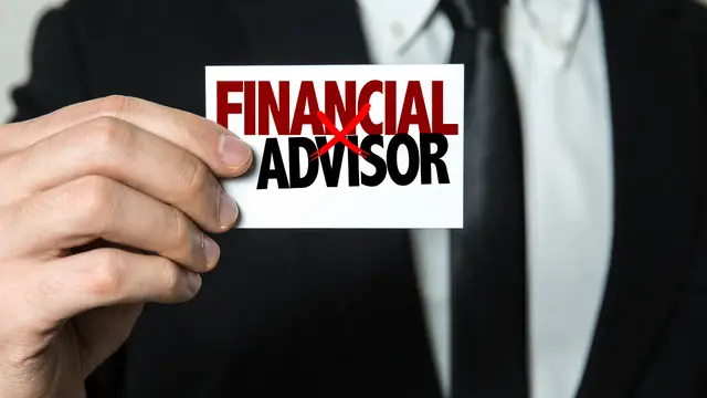 Person holding a card that says financial advisor with an x through it.