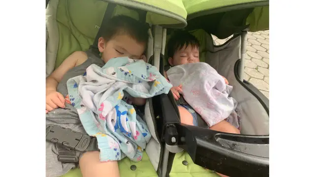 Kiddos sleeping in the double stroller in NYC