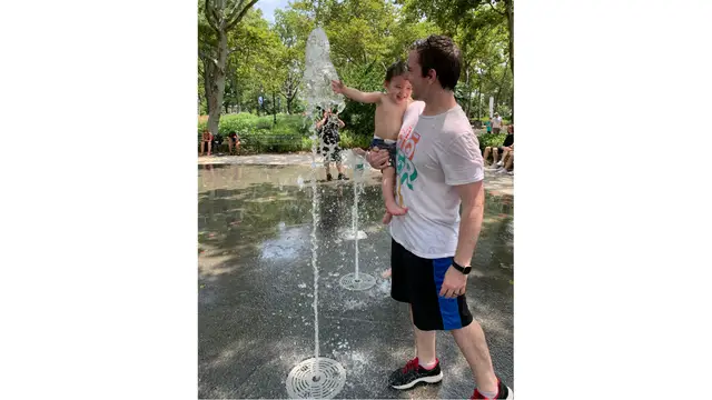 Me with my son at a splash pad in NYC
