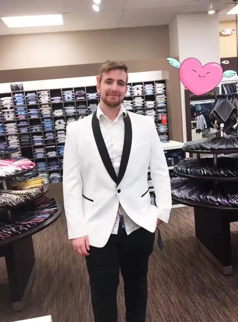 Me trying on a white tuxedo jacket that I bought for just one hundred dollars
