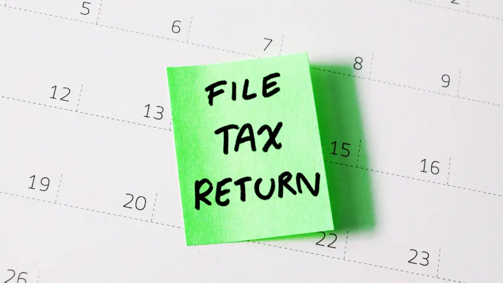 Calendar that has a post it note with the words "FILE TAX RETURN"