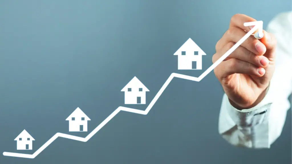 Person with a pen and a line graph going up with many real estate properties on the line