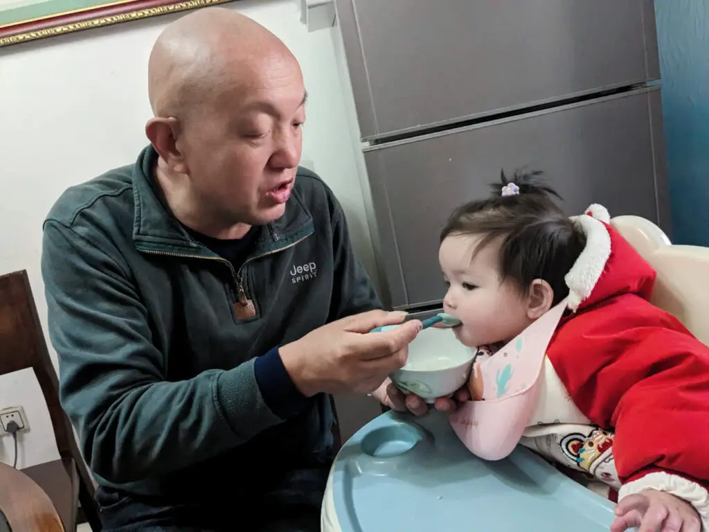 Chinese father-in-law feeding our baby girl 